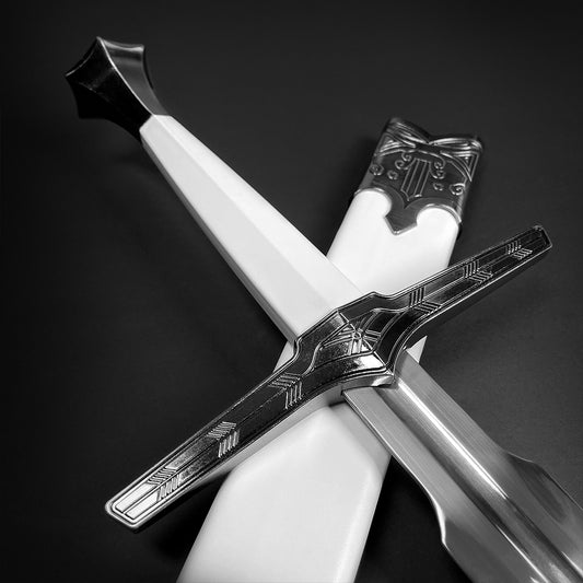 White sword hilt with ornate crossguard.