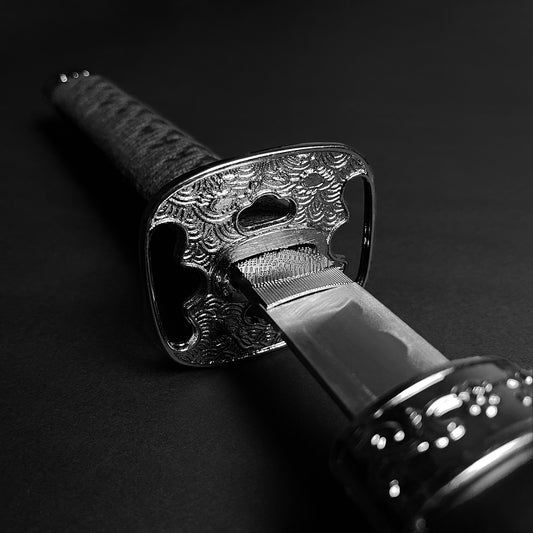 Close-up katana tsuba and blade