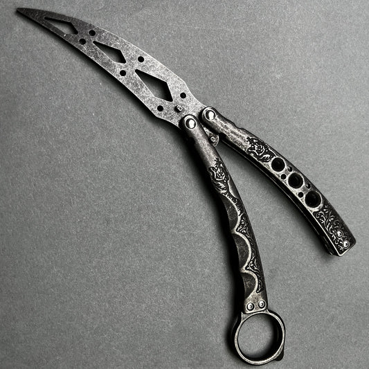Guild Arms black butterfly trainer knife with intricate cutout design and textured handles