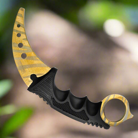 Falcon trainer karambit knife with curved gold blade and black ergonomic handle for safe practice