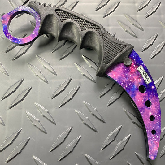 Falcon purple karambit trainer knife with galaxy design and textured black grip on metal background