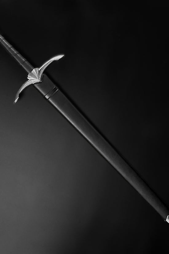 A medieval longsword inside a black scabbard - Guild Arms.