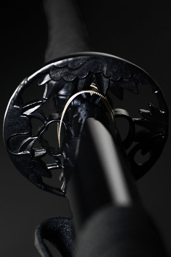 Black katana tsuba guard closeup- Guild Arms.