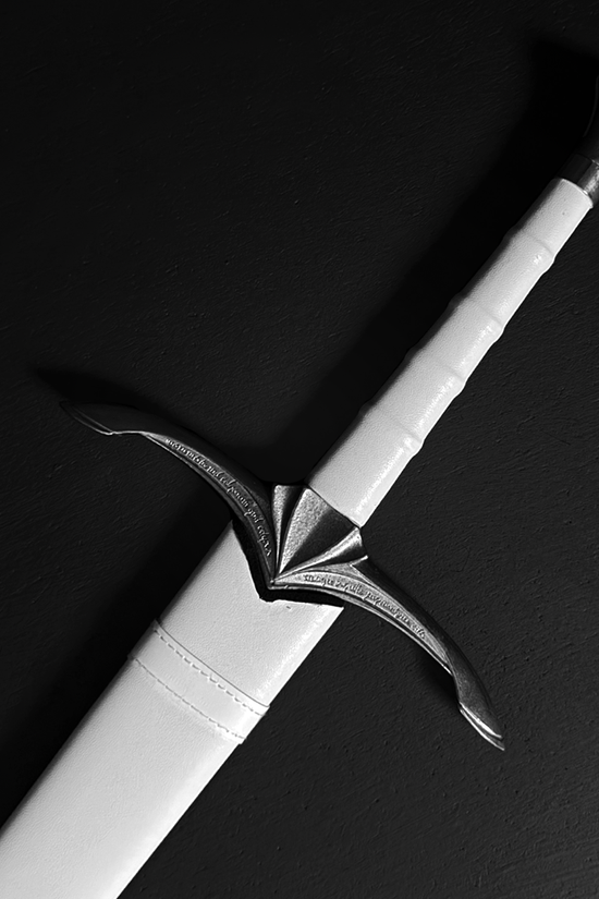 Medieval sword hilt in white scabbard | Guild Arms