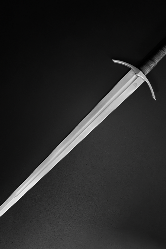 Medieval sword leather-wrapped handle and peened pommel detail