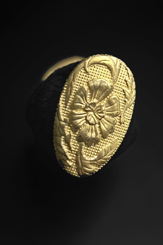Gold oval ring with floral design.  | Guild Arms
