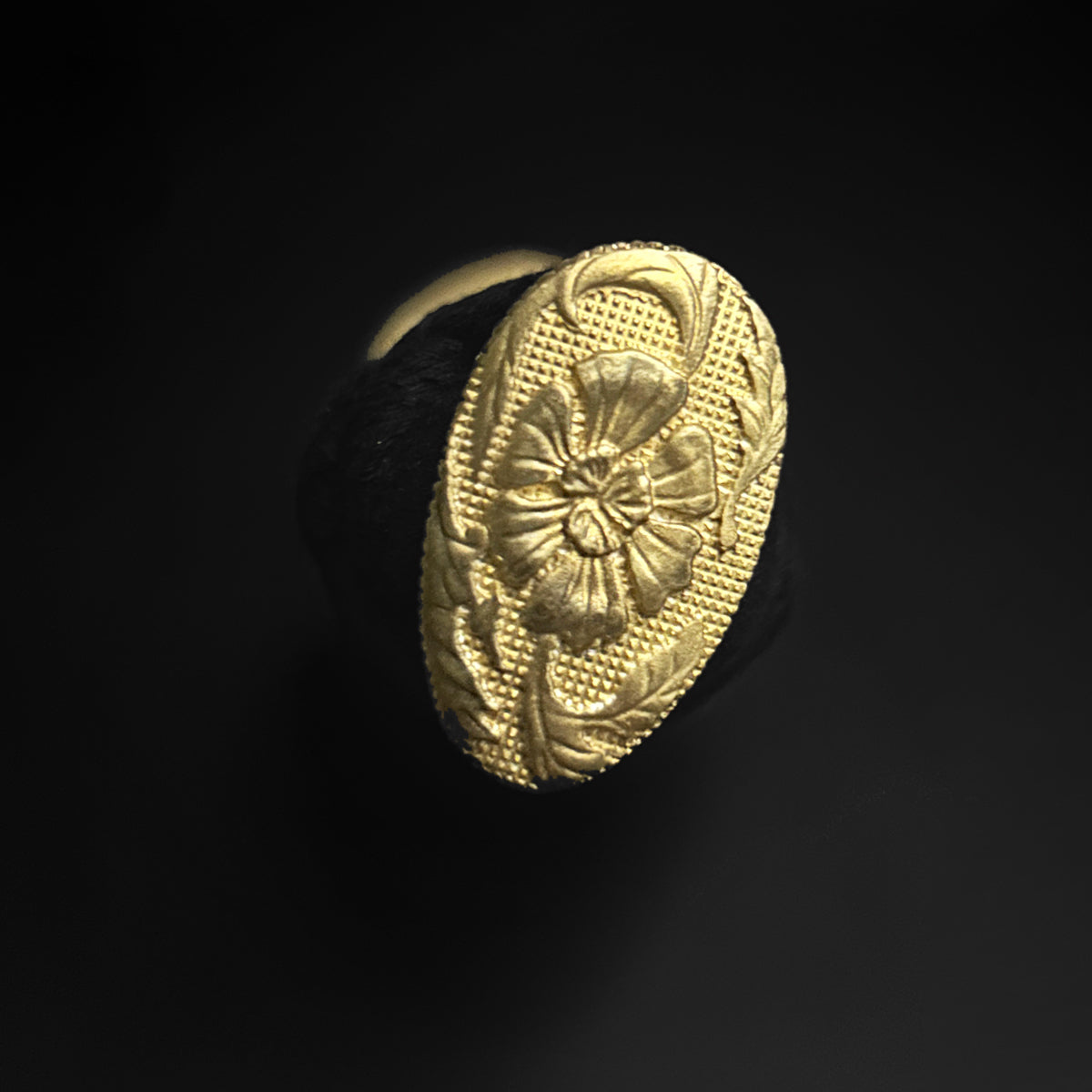 Gold oval ring with floral design.  | Guild Arms