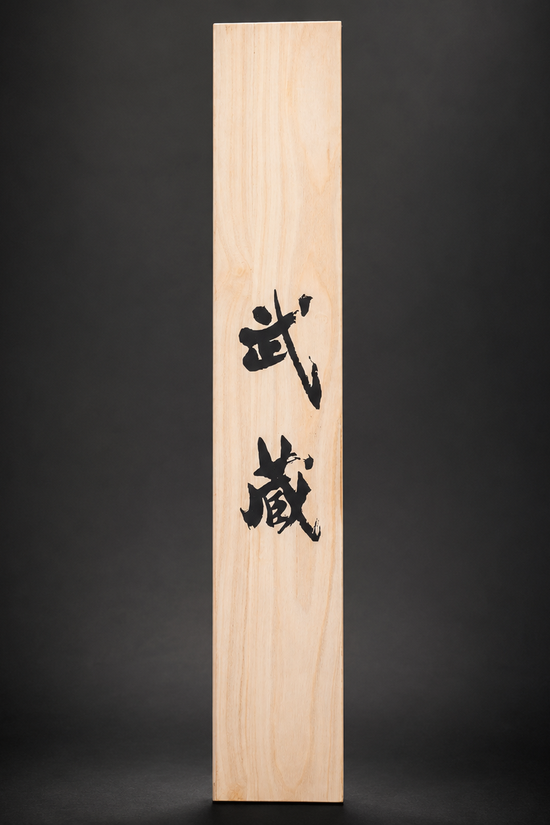 Japanese calligraphy "Musashi" on light wood. | Guild Arms