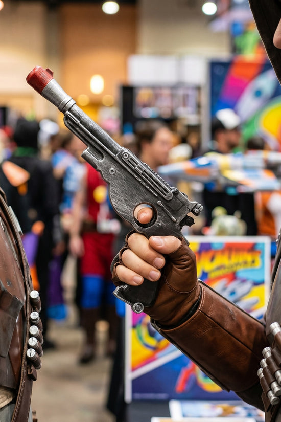 Cosplayer holding prop blaster at convention