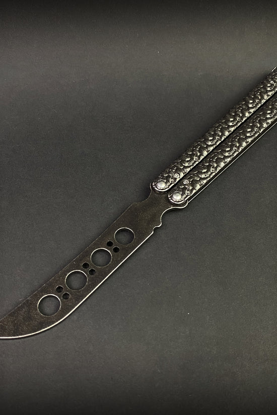 Skull-handle butterfly knife with skeletonized blade