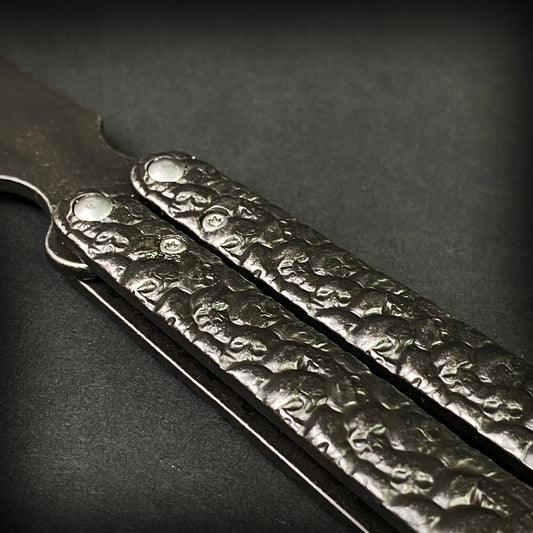 Textured skull handle on butterfly knife