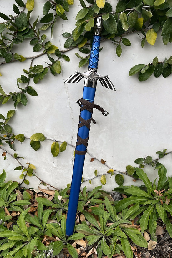 Blue fantasy sword standing among garden plants