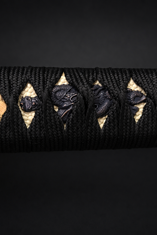 Katana handle with black dragon wrap. | Guild Arms