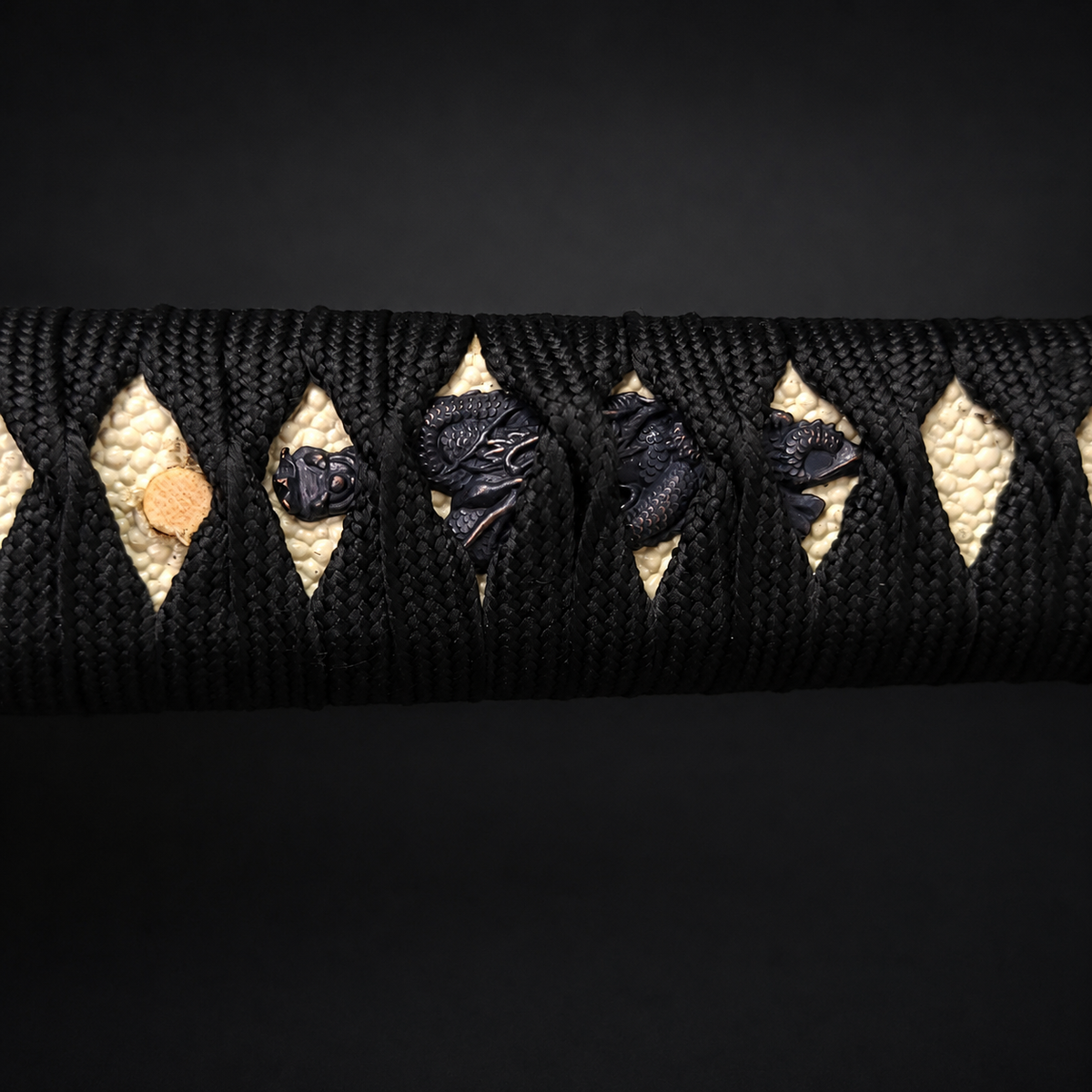 Katana handle with black dragon wrap. | Guild Arms