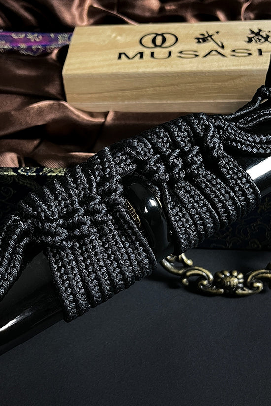 Black braided cord on katana scabbard- Guild Arms.