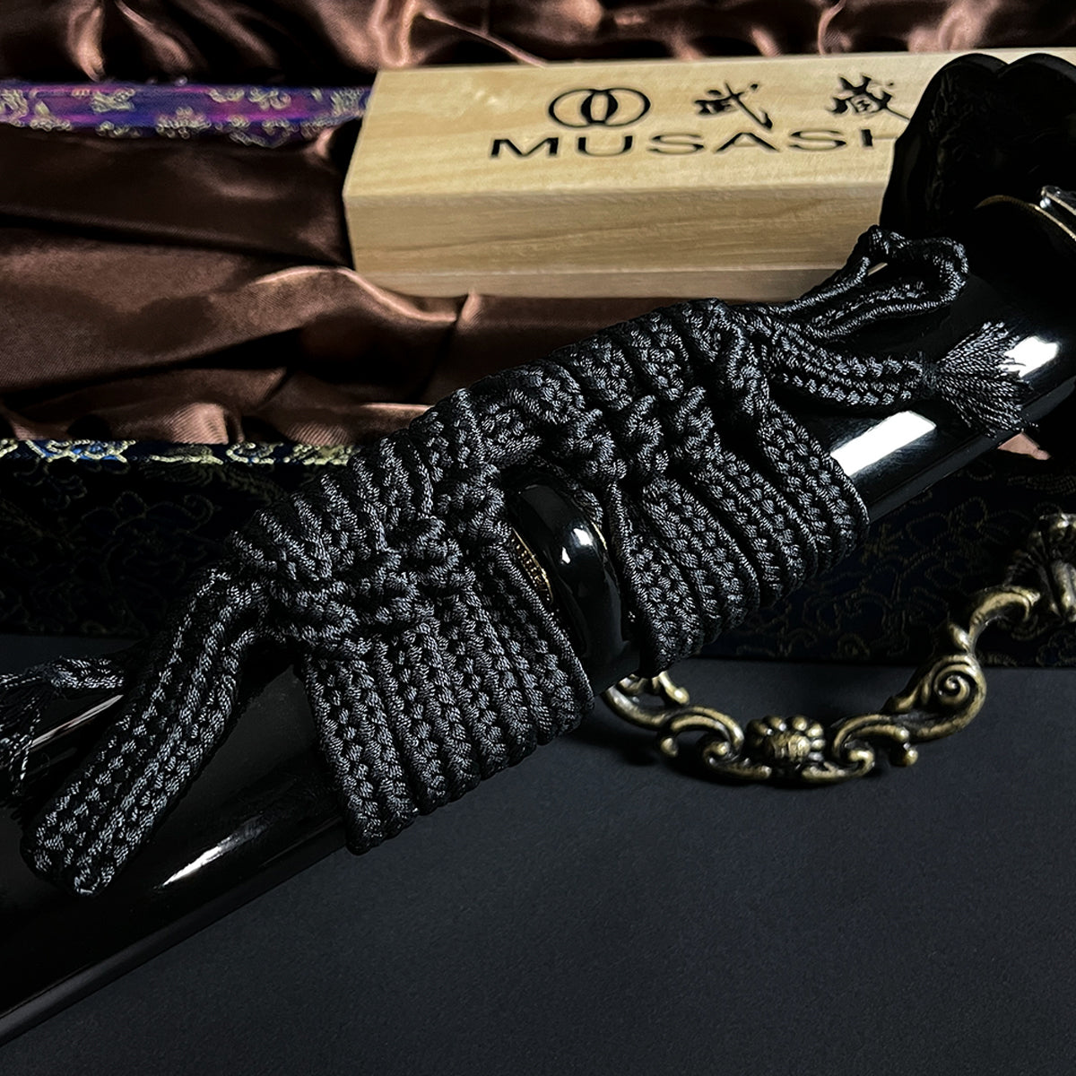 Black braided cord on katana scabbard- Guild Arms.
