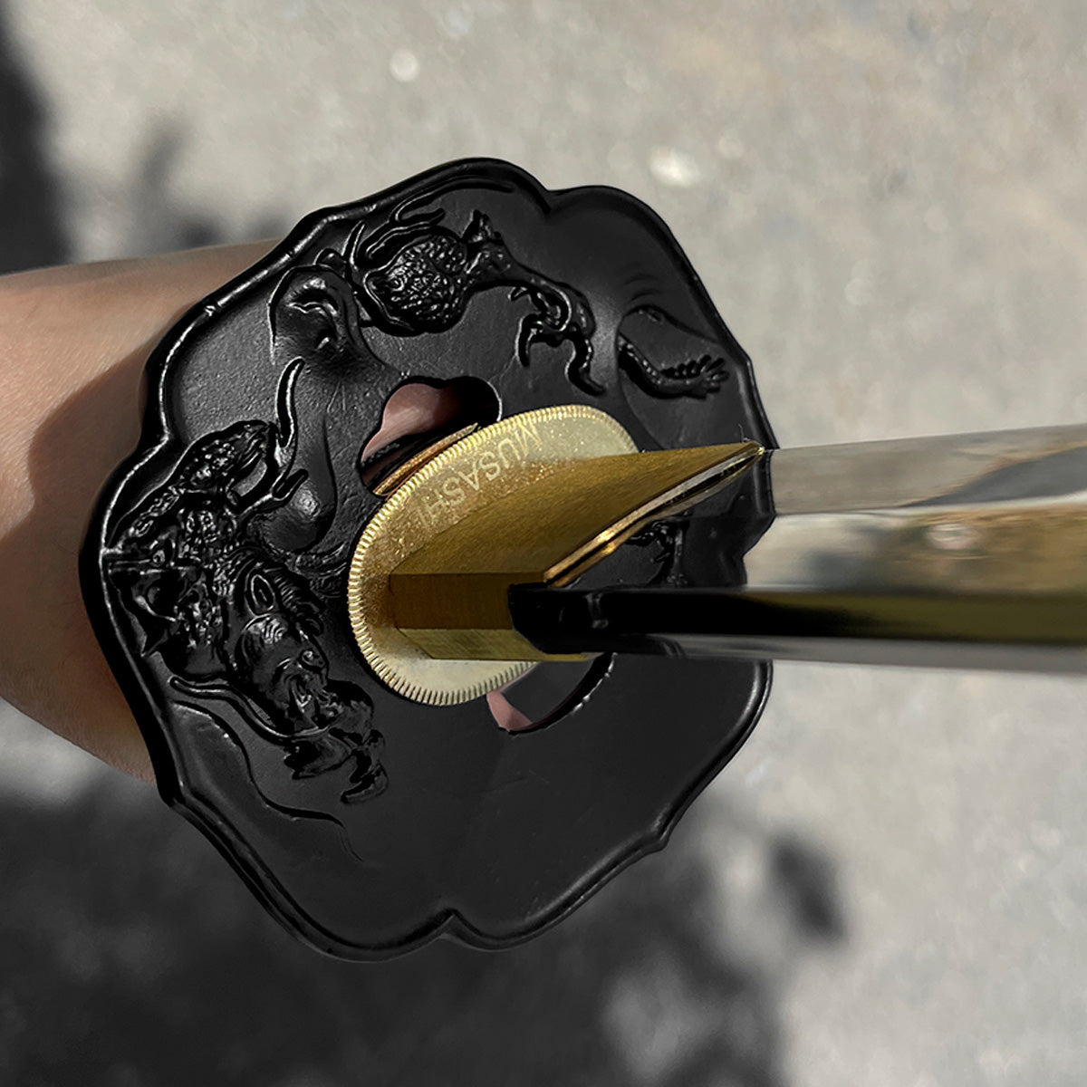 A close-up of a katana's tsuba - Guild Arms.