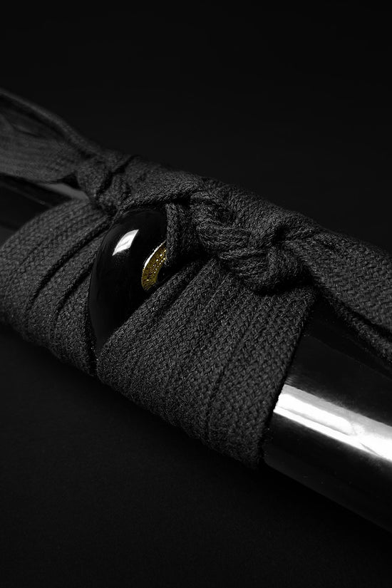 Black cord wrapped on katana- Guild Arms.