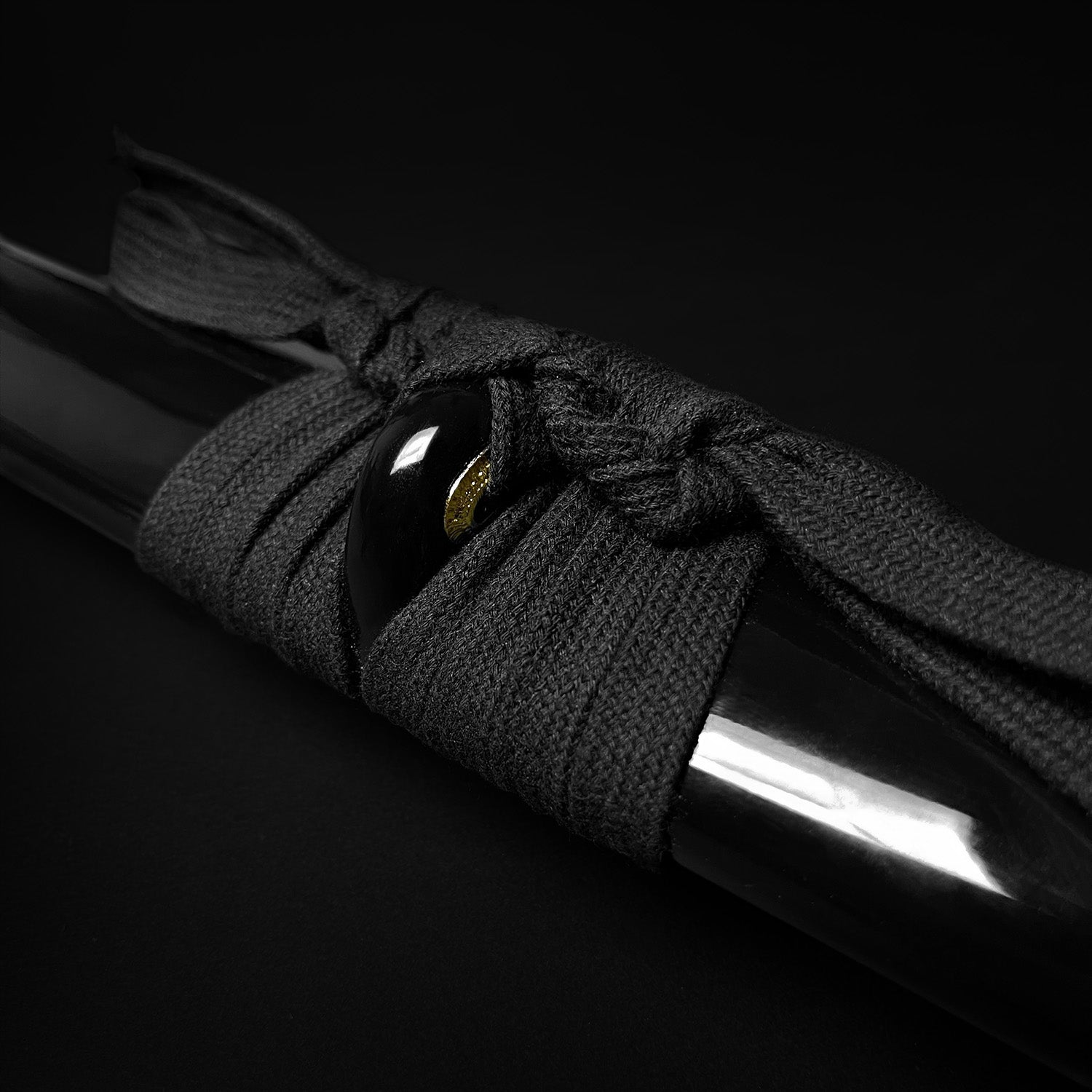 Black cord wrapped on katana- Guild Arms.