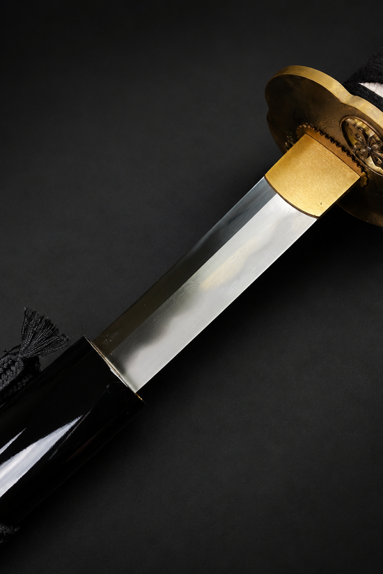 Black tactical knife on dark surface | Guild Arms