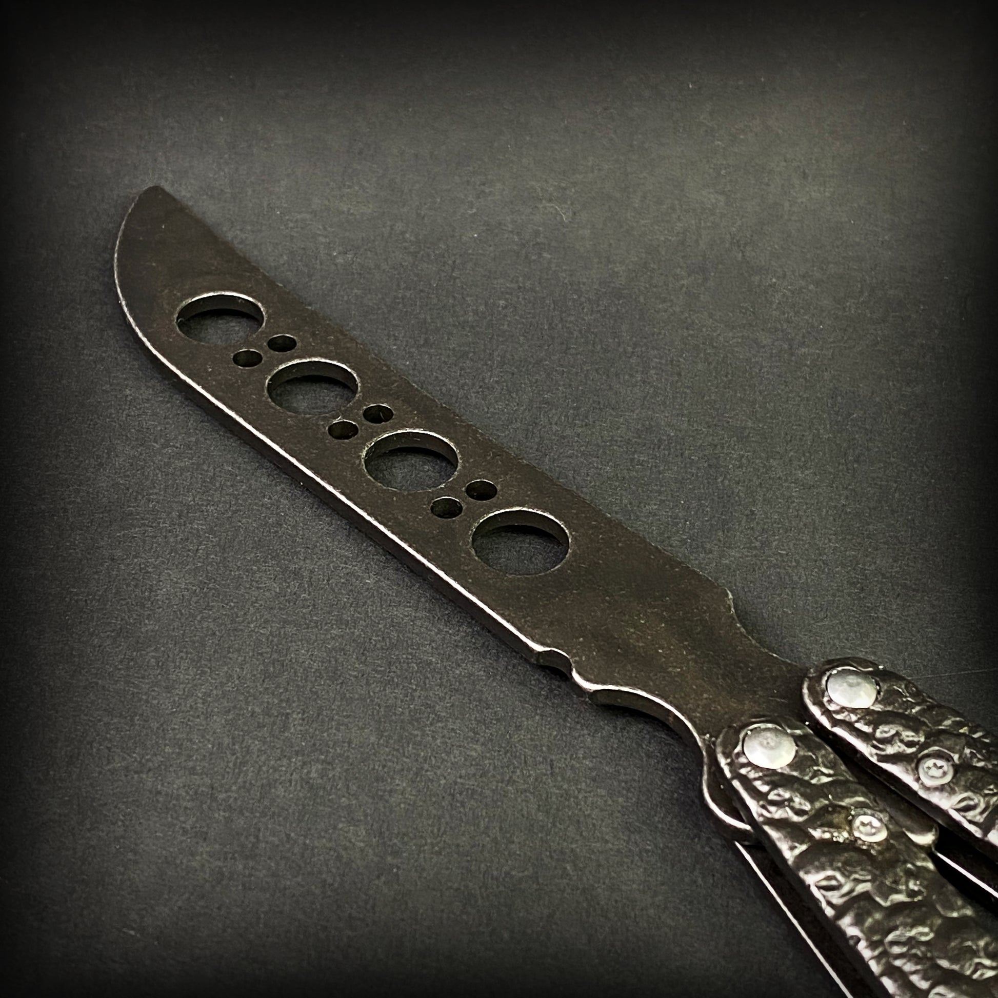 Big Boy's Black Butterfly Trainer featuring a sleek design and multiple practice holes for skill building