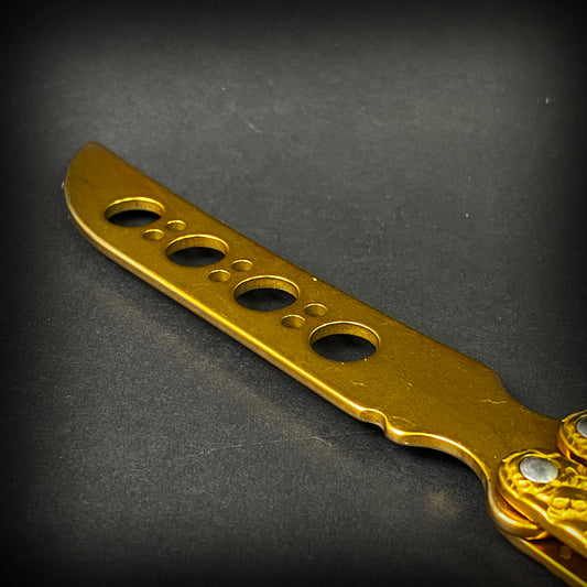 Big Boy's Gold Butterfly Trainer with a shiny blade and multiple safety holes for practice and training