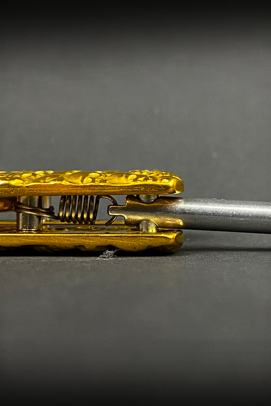 Detailed close-up of Big Boy's Gold Butterfly Trainer showcasing its unique design and craftsmanship