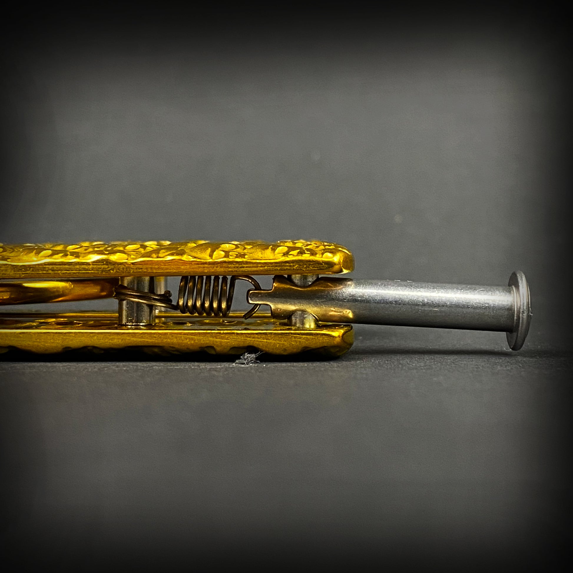 Detailed close-up of Big Boy's Gold Butterfly Trainer showcasing its unique design and craftsmanship