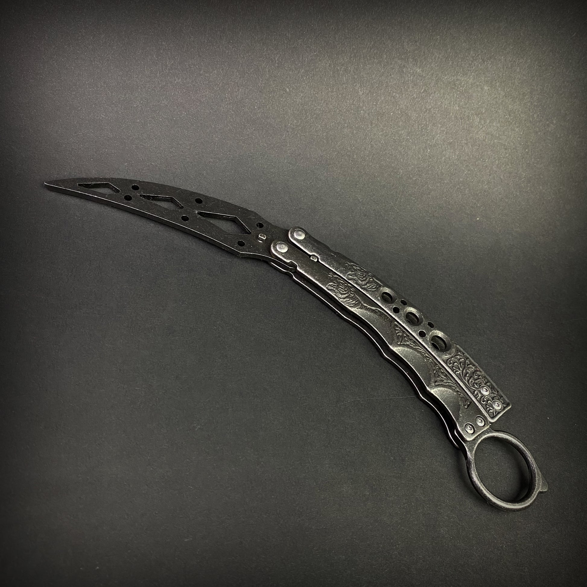 Guild Arms black butterfly trainer knife with detailed handle and curved blade design