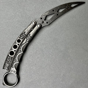 Guild Arms black butterfly trainer knife with ornate engraved handles and skeletonized blade