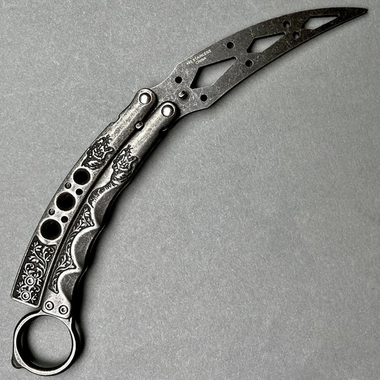 Guild Arms black butterfly trainer knife with ornate engraved handles and skeletonized blade