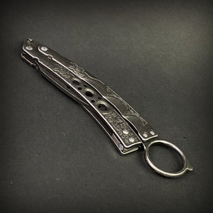 Guild Arms black butterfly trainer knife with engraved metal handles on black background