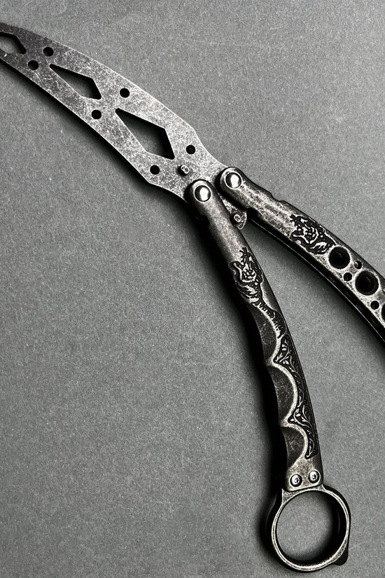 Guild Arms black butterfly trainer knife with intricate cutout design and textured handles