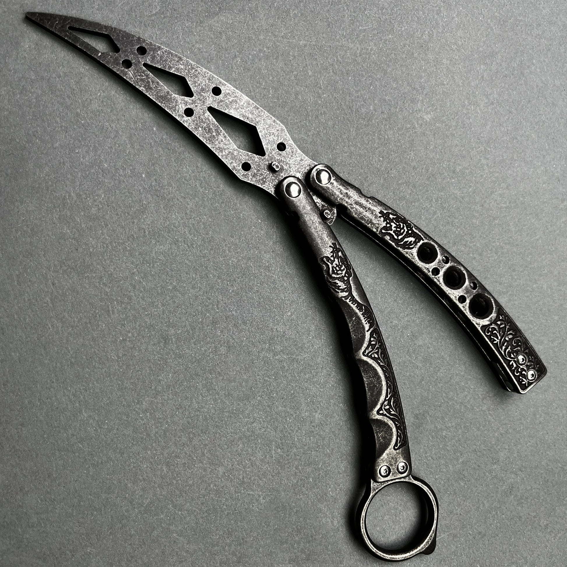 Guild Arms black butterfly trainer knife with intricate cutout design and textured handles