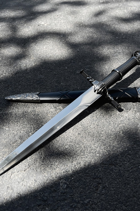 Black Wolf Head Medieval Dagger w/Plastic Scabbard displayed on a surface with sunlight casting shadows