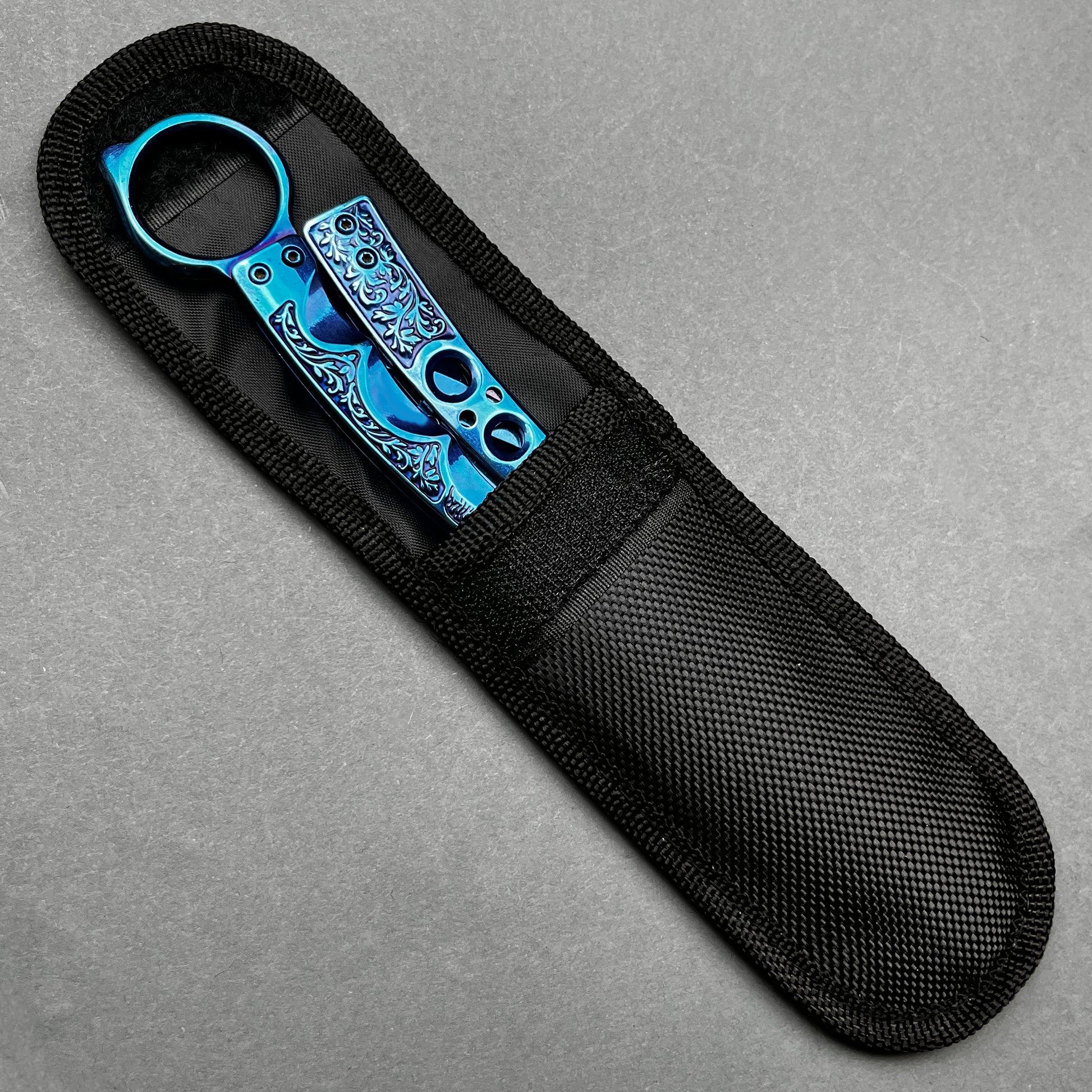 Guild Arms blue practice butterfly knife for beginners with intricate design in black fabric sheath