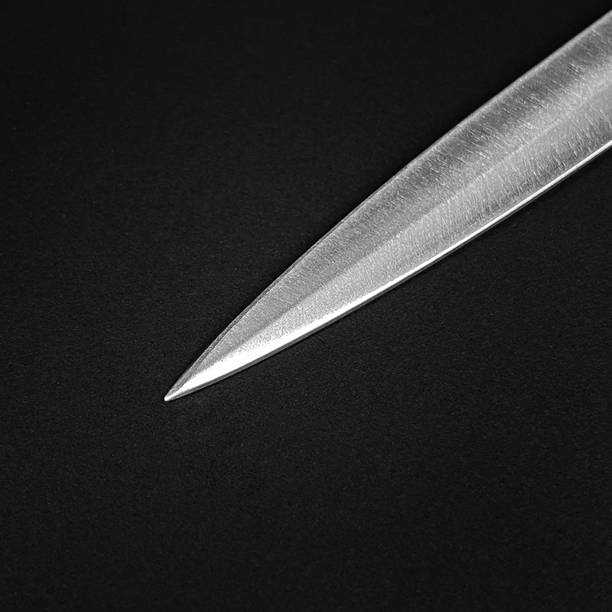 Detailed view of a Classic Medieval Dagger blade with a sharp pointed tip and polished finish