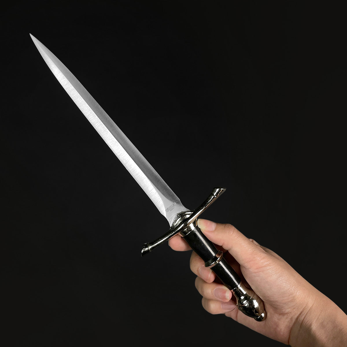 Classic Medieval Dagger with a sleek blade and elegant handle held by a hand