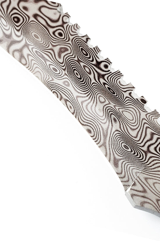 Guild Arms survival knife close up showing damascus pattern fixed blade hunting knife with serrated spine