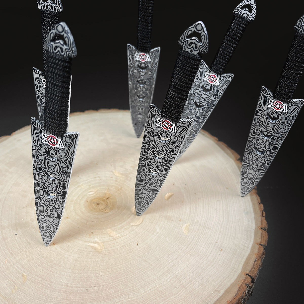 Falcon 6 PC 5 7/8" Damascus Pattern Throwing Knife Set displayed on a wooden surface
