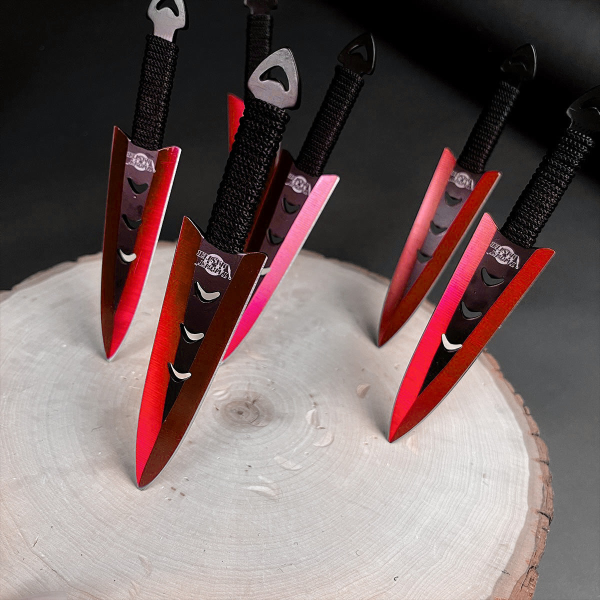 Falcon 6 PCS Red Throwing Knives Set arranged on a wooden surface showcasing their vibrant design