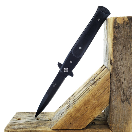 Falcon 8 3/4" Black Spring Assisted Stiletto Knife displayed on a wooden surface for easy access.