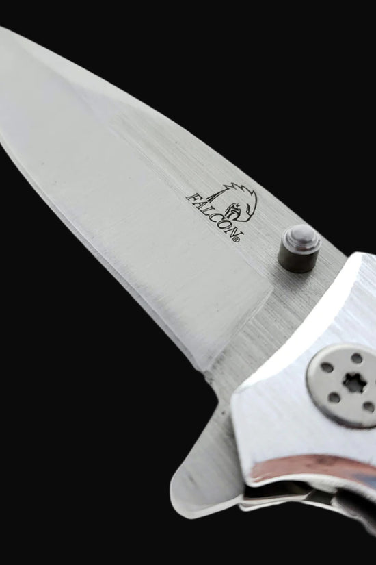 Close-up of Falcon EDC knife wood handle spring assisted pocket knife blade and logo