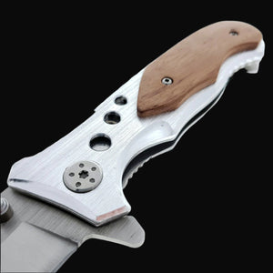 Close-up of Falcon EDC knife wood handle on spring assisted pocket knife with metal blade