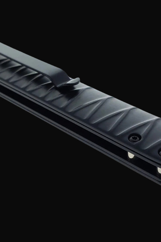 Black folded Falcon tanto spring assisted pocket knife . Closed textured handle with deep pocket clip for everyday carry