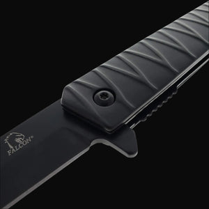 Close up view of Falcon tanto spring assisted pocket knife . black tanto blade and textured ridged handle with logo