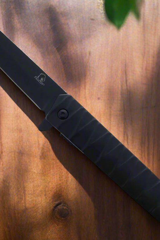 Black Falcon tanto spring assisted pocket knife . Black tanto blade open with textured black handle EDC