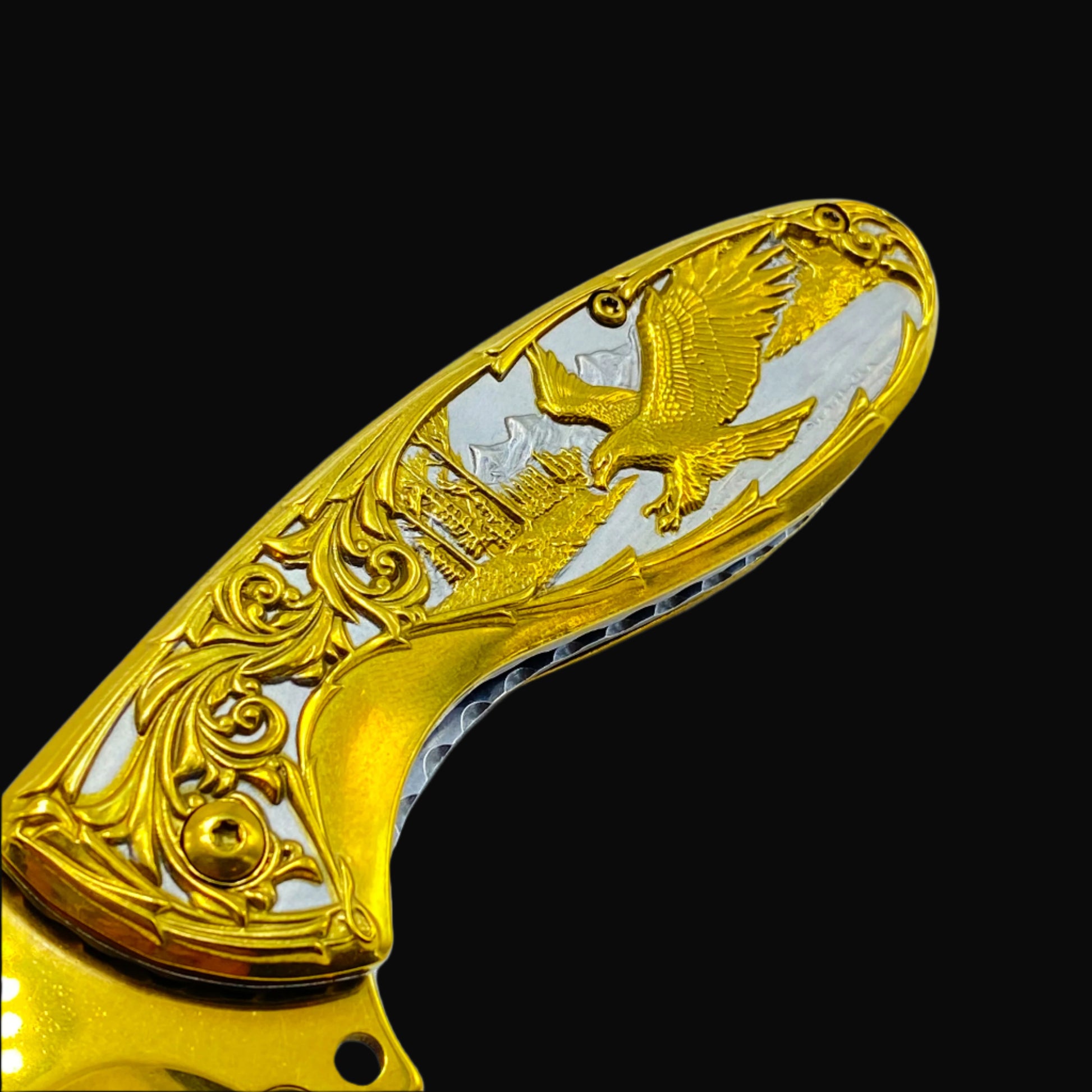 Falcon gold spring assisted knife handle with intricate eagle and scrollwork design