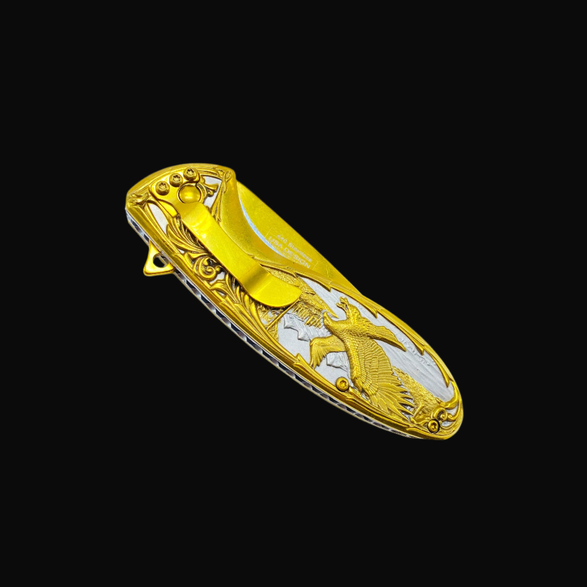Falcon gold spring assisted knife with detailed eagle design and pocket clip on black background