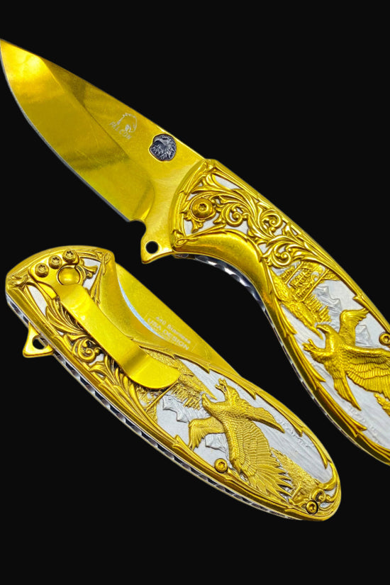 Falcon gold spring assisted knife with ornate eagle design and decorative handle detailing